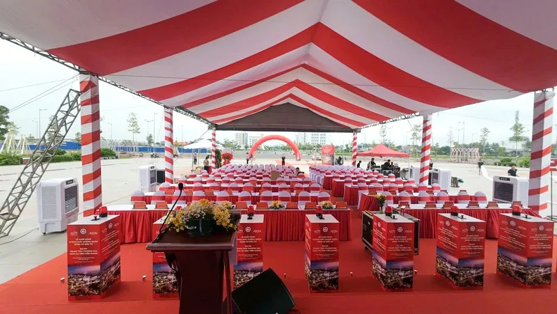 Nhà bạt đỏ trắng phục vụ lễ khởi công doanh nghiệp ngoài trời.